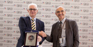 GianFranco Lorenzini, vice president of global sales for Dayco, accepts the Best Plant Award from Pascal Gignoux, executive manager of supplier quality and development for PSA.
